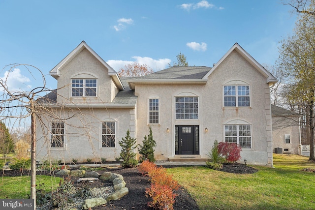 french country inspired facade with a front yard