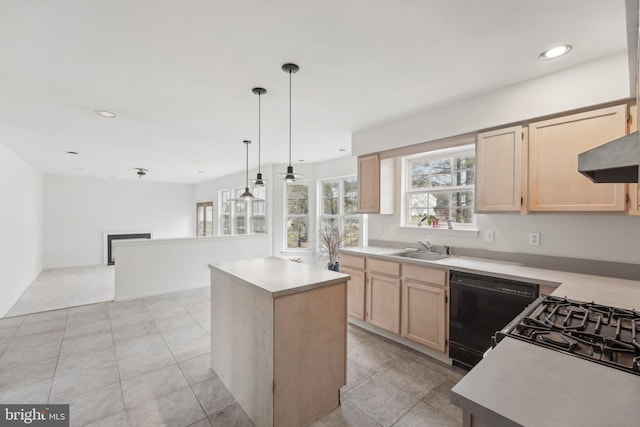 kitchen featuring dishwasher, a center island, hanging light fixtures, and light brown cabinets