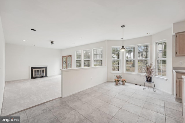 unfurnished dining area with light carpet