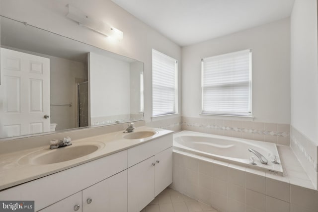 bathroom featuring tile patterned floors, vanity, and separate shower and tub