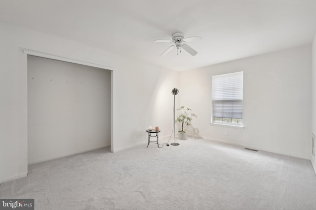 carpeted empty room with ceiling fan