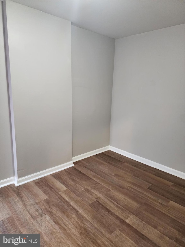 unfurnished room with hardwood / wood-style flooring