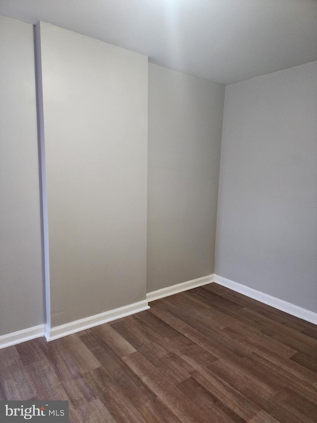 spare room with dark hardwood / wood-style flooring