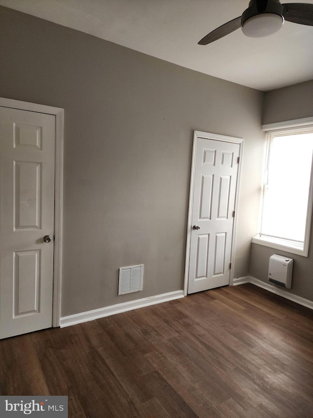 unfurnished room featuring ceiling fan and dark hardwood / wood-style floors