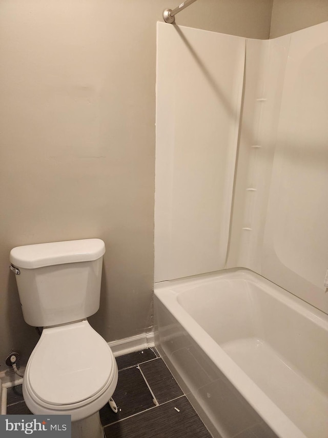 bathroom with tub / shower combination and toilet