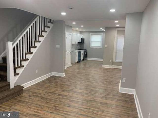 unfurnished living room with dark hardwood / wood-style floors