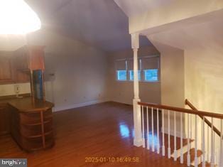 bonus room with vaulted ceiling and dark hardwood / wood-style floors