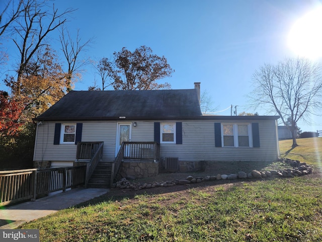 view of front facade with central AC and a front lawn