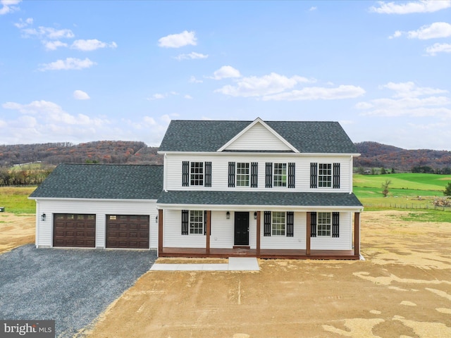 view of front facade featuring a porch and a garage