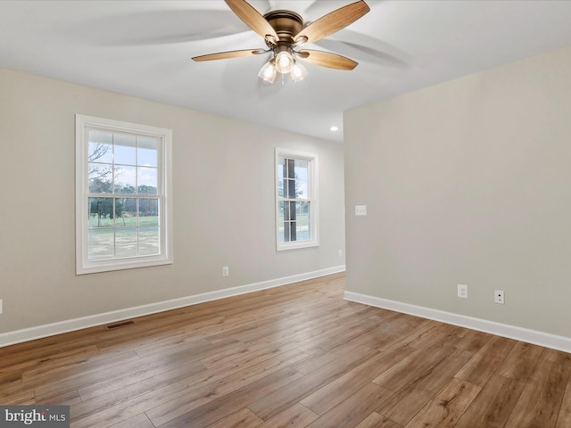 empty room featuring ceiling fan and light hardwood / wood-style floors