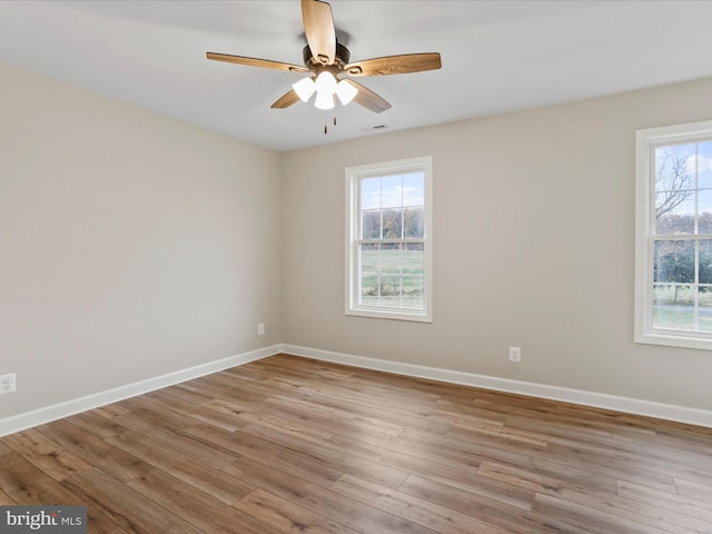 spare room featuring ceiling fan, plenty of natural light, and light hardwood / wood-style floors