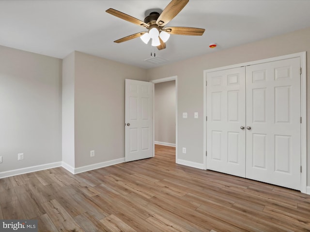 unfurnished bedroom featuring a closet, ceiling fan, and light hardwood / wood-style flooring