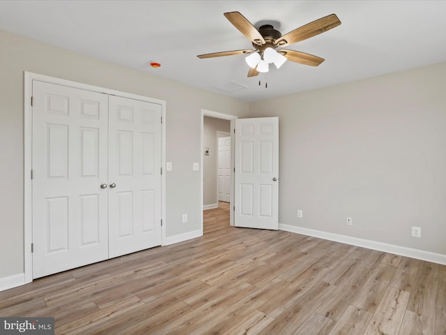 unfurnished bedroom featuring light wood-type flooring, a closet, and ceiling fan