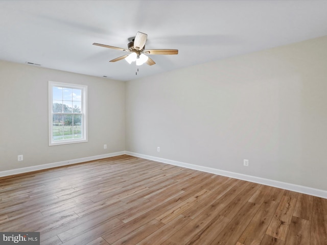 spare room featuring light hardwood / wood-style floors and ceiling fan