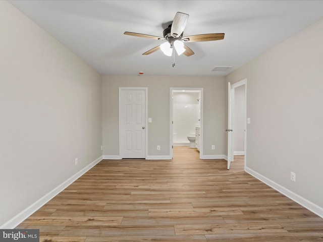 unfurnished bedroom featuring connected bathroom, light hardwood / wood-style floors, and ceiling fan