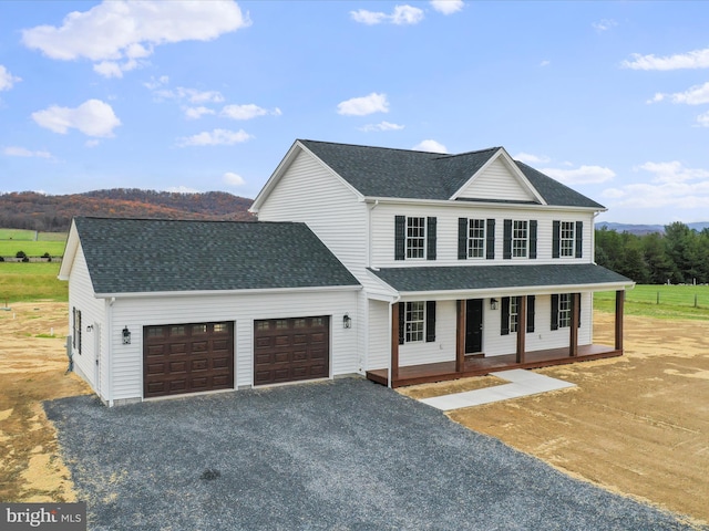 view of front of property with a porch and a garage