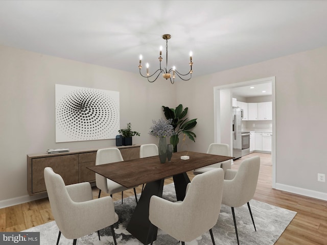 dining space with a notable chandelier and light wood-type flooring