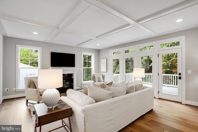 living room featuring beam ceiling, light wood-type flooring, and coffered ceiling