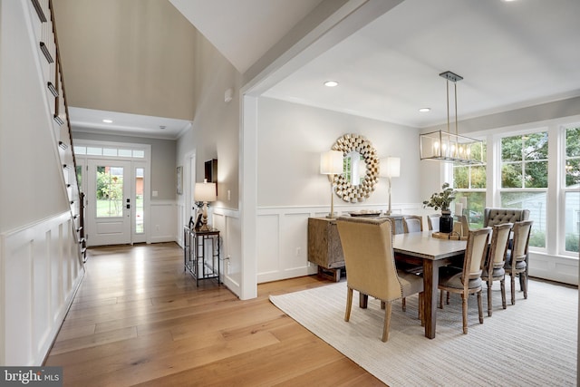 dining room featuring crown molding and light hardwood / wood-style flooring