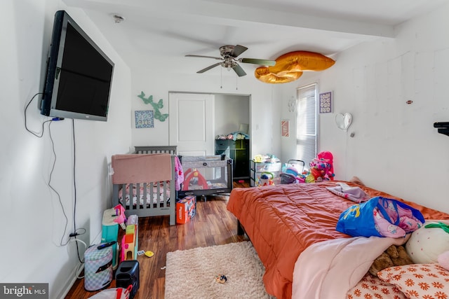 bedroom with beam ceiling, ceiling fan, and dark wood-type flooring