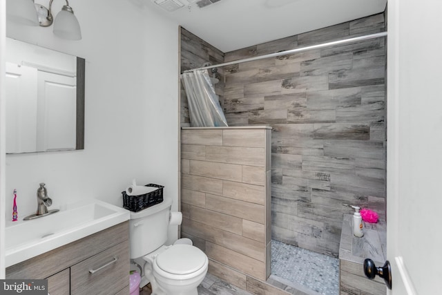 bathroom with toilet, vanity, and a shower with shower curtain