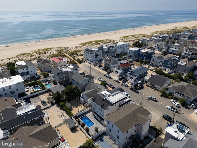 drone / aerial view featuring a view of the beach and a water view