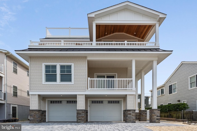 view of front facade with a garage and a balcony