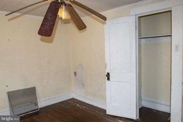 unfurnished bedroom with crown molding and dark hardwood / wood-style flooring