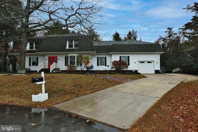 view of front of house with a garage and a front lawn