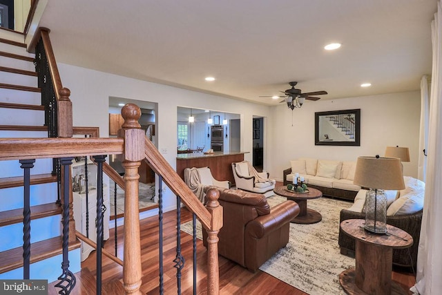 living room featuring hardwood / wood-style flooring and ceiling fan