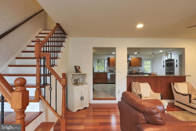 living room featuring hardwood / wood-style flooring and sink