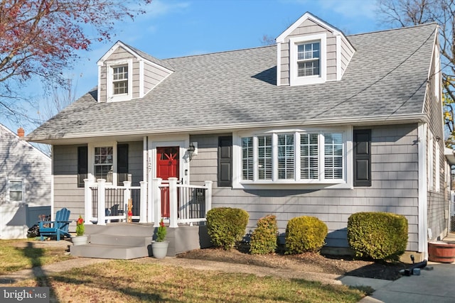 new england style home featuring a front yard