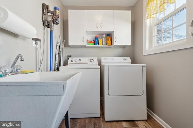 laundry room featuring cabinets, independent washer and dryer, and dark wood-type flooring