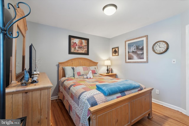 bedroom with hardwood / wood-style floors