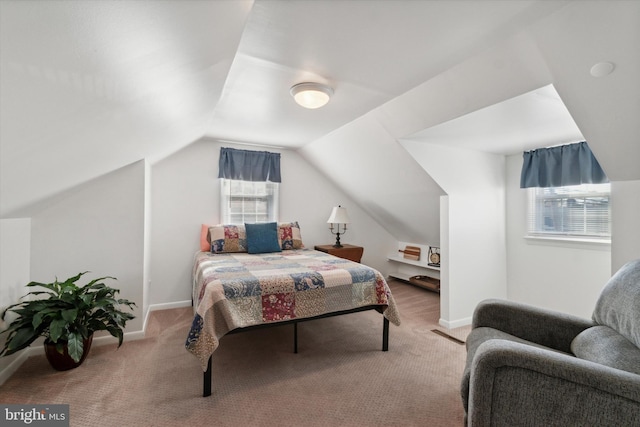 carpeted bedroom featuring lofted ceiling