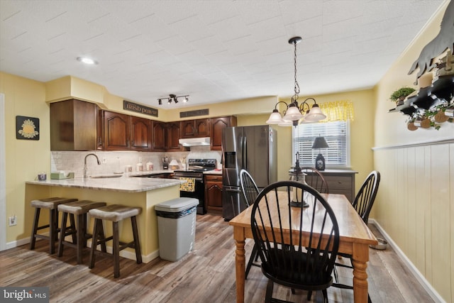 kitchen with sink, light hardwood / wood-style floors, and appliances with stainless steel finishes