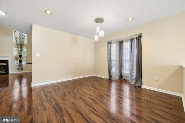 empty room with dark hardwood / wood-style flooring