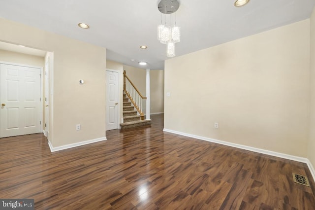 interior space with dark hardwood / wood-style floors and a notable chandelier