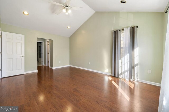 empty room featuring high vaulted ceiling, ceiling fan, and dark wood-type flooring