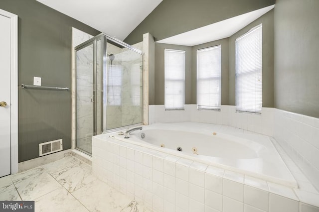 bathroom featuring separate shower and tub and lofted ceiling