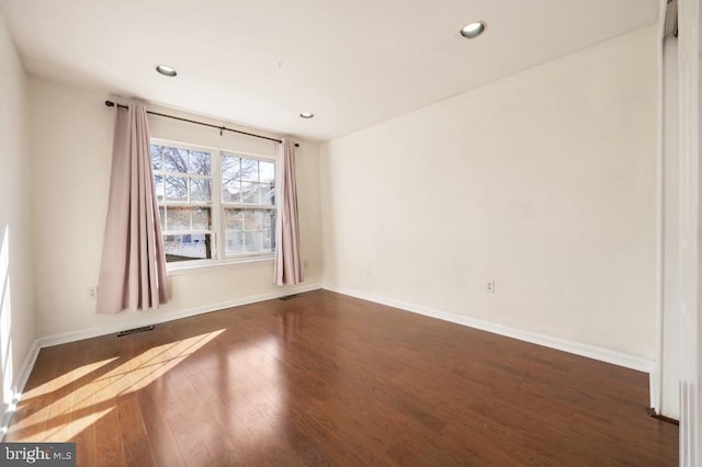 spare room featuring dark hardwood / wood-style floors