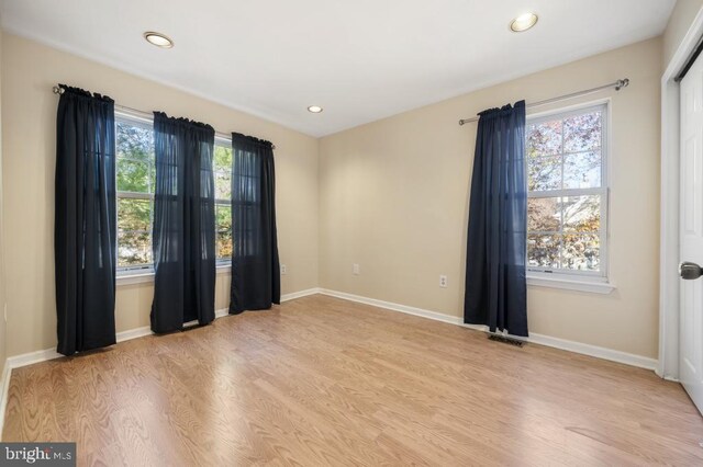 empty room with light hardwood / wood-style floors