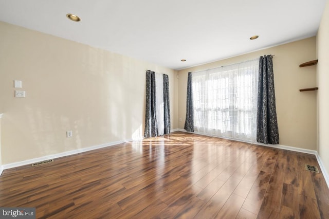 spare room featuring dark wood-type flooring