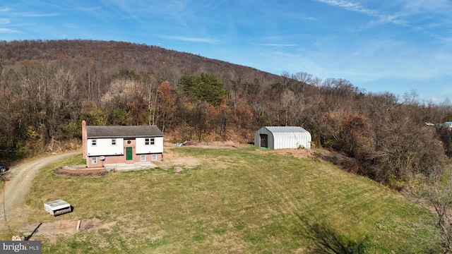 birds eye view of property featuring a mountain view