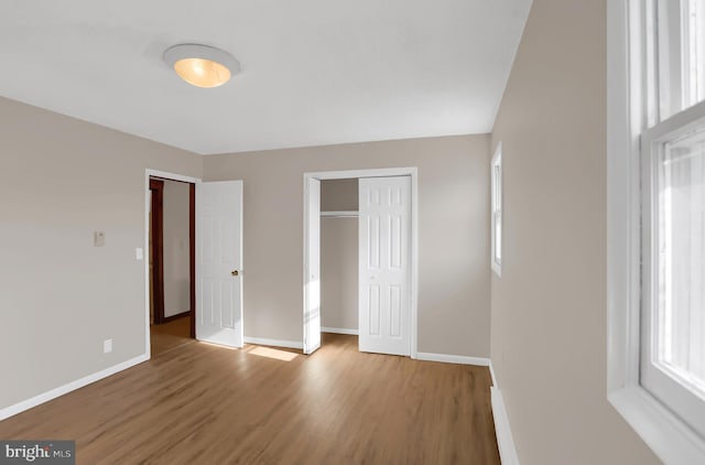 unfurnished bedroom with hardwood / wood-style floors