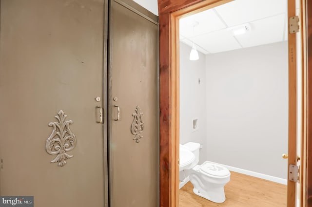 bathroom featuring hardwood / wood-style flooring and toilet