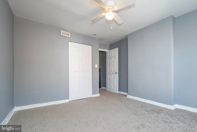 carpeted empty room with ceiling fan