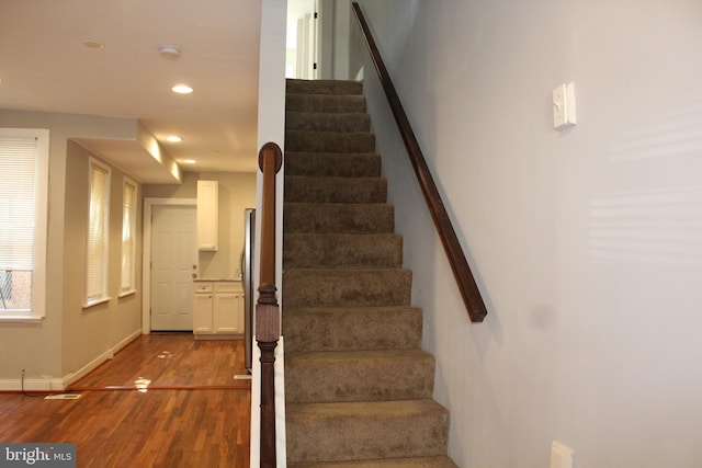 staircase with hardwood / wood-style flooring