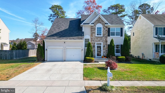 view of front of home featuring a front yard and a garage