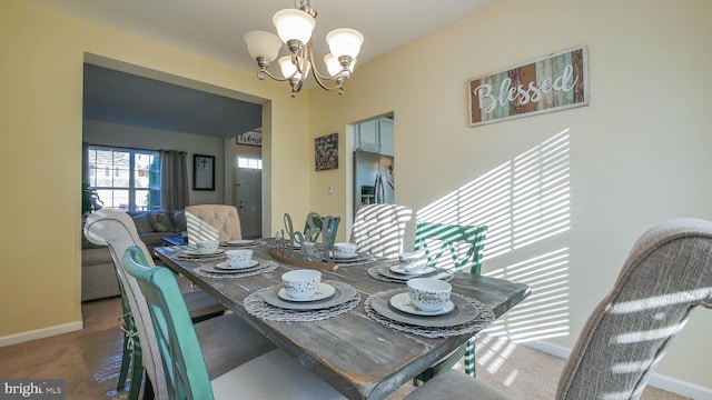 dining space with a notable chandelier